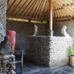 Open-air stone bathroom with tropical planting