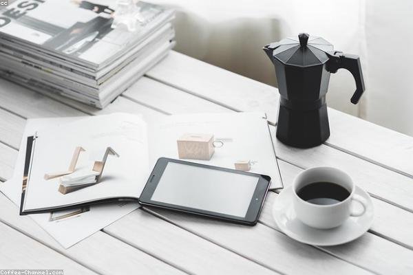 Digital nomad at a desk with a laptop and monitor